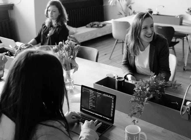 Picture of women in an office sitting at their computers